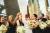 Picture of the bride and her bridesmaids outside The Lowry with cream and pink flowers