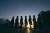 Picture of silouettes of the groomsmen in a line with the sunset in the background